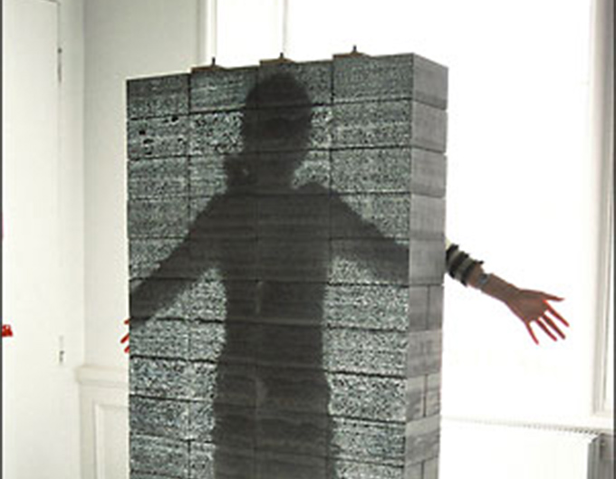 Mujer demuestra que su silueta se ve detrás de un muro de concreto translúcido Mujer demuestra que su silueta se ve detrás de un muro de concreto translúcido