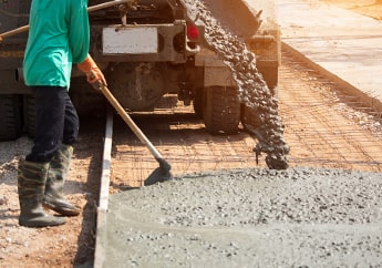 Camión revolvedora de concreto descargando premezclado en una obra. Camión revolvedora de concreto descargando premezclado en una obra.
